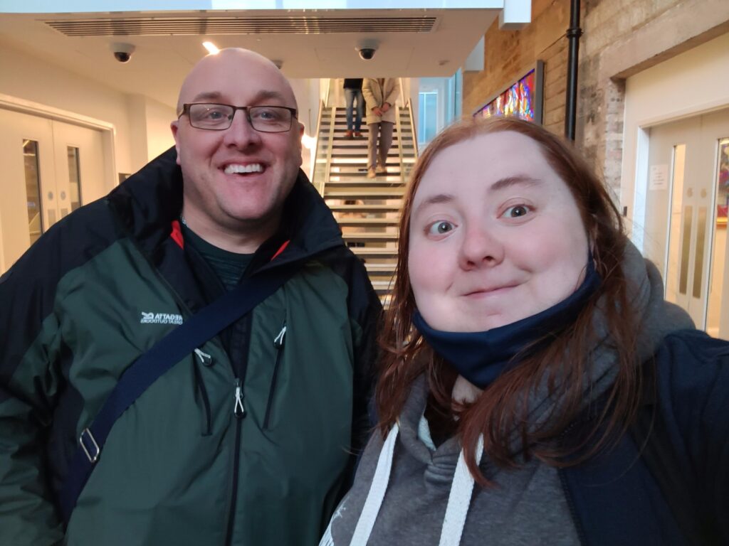 Sessional worker Colin is smiling with Ambassador Emma 